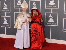 Nicki Minaj, right, arrives at the 54th annual Grammy Awards on Sunday, Feb. 12, 2012, in Los Angeles. (AP Photo/Chris Pizzello)