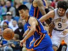 New York Knicks' Tyson Chandler, centre, sets a pick on Minnesota Timberwolves' Ricky Rubio, right, as the Knicks' Jeremy Lin, left, chases a loose ball duringan NBA game Saturday, Feb. 11, 2012, in Minneapolis. (AP Photo/Jim Mone)