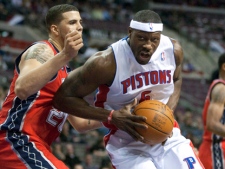 Detroit Pistons' Ben Wallace, right, drives to the basket against the New Jersey Nets' Jordan Williams during an NBA game Friday, Feb. 10, 2012, in Auburn Hills, Mich. The Pistons won 109-92. (AP Photo/Duane Burleson)