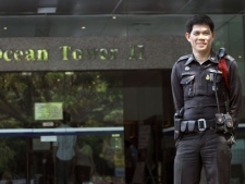A Thai police officer stands guard outside a building where the Israeli Embassy is located, a day after multiple explosions left four civilians wounded and led to the capture of two Iranian nationals on Wednesday, Feb. 15, 2012, in Bangkok, Thailand. (AP Photo/Apichart Weerawong)