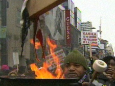  A protester holds a cauldron near Yonge and Dundas Streets Thursday afternoon. (CP24)