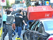 A man identiifed as Ryan Dickinson throws a newspaper box in an image taken from video. THE CANADIAN PRESS/HO-Global News