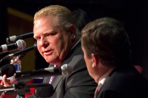 Doug Ford, left, looks over at John Tory as he takes part in a mayoral debate in Toronto on Tuesday, Sept. 23, 2014. (The Canadian Press/Chris Young)