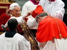 Newly-elected Cardinal, Archbishop of Toronto Thomas Christopher Collins, of Canada, receives his biretta hat from Pope Benedict XVI during his elevation inside the St. Peter's Basilica at the Vatican, Saturday, Feb. 18, 2012. Pope Benedict XVI on Saturday brought 22 new Catholic churchmen into the elite club of cardinals who will elect his successor, in a greatly simplified ceremony that took account of evidence the 84-year-old pontiff is slowing down. (AP Photo/Andrew Medichini)