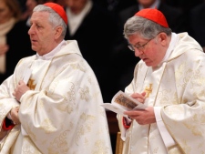 Newly-elected Cardinal, Archbishop of Toronto Thomas Christopher Collins, right, next to newly-elected Cardinal, Archbishop Emeritus of Alessandria, Italy, Giuseppe Versaldi, reads the mass book during a Mass celebrated by Pope Benedict XVI in St. Peter's Basilica at the Vatican a day after installing them as cardinals, Sunday, Feb. 19, 2012. (AP Photo/Pier Paolo Cito) 
