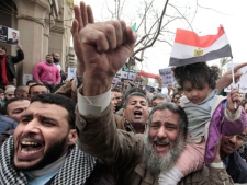 Egyptian protesters shout slogans during a protest against Syrian President Bashar al-Assad at Tahrir Square, the focal point of Egyptian uprising in Cairo, Egypt, Friday, Feb. 17, 2012. (AP Photo/Amr Nabil)