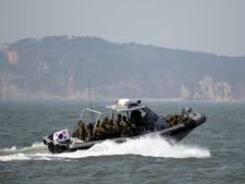 South Korean navy sailors patrol South Korea's western Yeonpyong Island after conducting live-fire military drills near the disputed sea border with North Korea on Monday, Feb. 20, 2012. (AP Photo/Yonhap, Bae Jung-hyun)