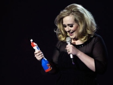 Adele reacts after winning the award for best British Female Solo Artist during the Brit Awards 2012 at the O2 Arena in London on Tuesday, Feb. 21, 2012. (AP Photo/Joel Ryan)