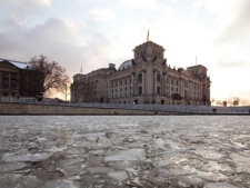 Floating ice covers the Spree River next to the Reichstag building, which houses the German parliament Bundestag, in Berlin, Germany, Friday, Feb. 3, 2012. (AP Photo/Gero Breloer)