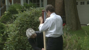 Mayoral candidate John Tory and former Liberal MPP Donna Casfield put up a campaign sign on Oct. 2. 