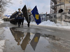 Members of Kosovo Security Force (KSF) reflected in a puddle of water march during a ceremony to mark the fourth anniversary of Kosovo's independence in the main street of Kosovo capital Pristina on Friday, Feb 17, 2012. Kosovo, which unilaterally declared independence from Serbia on Feb. 17, 2008, has so far been recognized by 87 states, including the United States and a majority of European Union members. ( AP Photo / Visar Kryeziu )