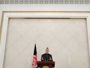 Afghan President Hamid Karzai speaks during a press conference at the presidential palace in Kabul, Afghanistan, Sunday, Feb. 26, 2012. Afghanistan's president renewed his calls for calm on Sunday in a televised address to the nation after the burning of Qurans at a U.S. base sparked five days of deadly protests and prompted the international military coalition to pull its advisers from Afghan ministries out of fear that they would become the next targets. (AP Photo/Musadeq Sadeq)