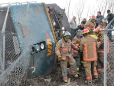 Emergency crews help extract VIA employees from the locomotive out of a train wreck in Burlington, Ont. on Sunday Feb. 26, 2012. THE CANADIAN PRESS/David Ritchie