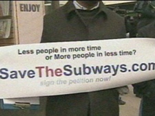A protester holds up a sign during the "Save the Subways" rally Sunday afternoon. (CP24)