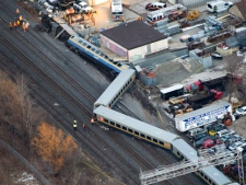 Emergency crews attend the scene where a Via Rail train was derailed in Burlington, Ont., on Sunday, Feb. 26, 2012. (THE CANADIAN PRESS/Nathan Denette)