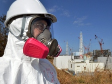 A journalist visits stricken Fukushima Dai-ichi nuclear power plant of Tokyo Electric Power Co. during a press tour led by TEPCO officials in Okuma, Japan on Tuesday, Feb. 28, 2012. (AP Photo/Yoshikazu Tsuno, Pool)