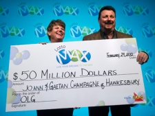 JoAnn Champagne, left, and her husband Gaetan Champagne, winners of a $50-million Lotto Max jackpot, hold a novelty cheque at Ontario Lottery and Gaming Corp. headquarters in Toronto on Wednesday, Feb. 29, 2012. The two won the jackpot on Dec. 30, 2011. (THE CANADIAN PRESS/Nathan Denette)