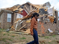 Ashley Matthews walks by her cousin's house after severe weather hit the Eagle Point subdivision in Limestone County, Ala. on Friday, March 2, 2012. (AP Photo/The Decatur Daily,  Jeronimo Nisa) 
