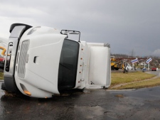 A semitrailer lies on its side in front of the remains of a gas station following severe storms on Friday, March 2, 2012, in Henryville, Ind. Tornadoes ripped across several small southern Indiana towns on Friday, killing at least three people and leaving behind miles of flattened devastation along the border with Kentucky. (AP Photo/Timothy D. Easley)