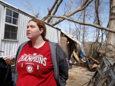 Valerie Holder talks Saturday about the tornado that tore through her neighborhood on Davis Mill Road on Friday night, on Saturday, March 3, 2012, in Harrison, Tenn. Emergency crews desperately searched for survivors Saturday after a violent wave of Midwest and Southern storms flattened some rural communities and left behind a trail of destruction: shredded homes, downed power lines and streets littered with tossed cars. (AP Photo/Chattanooga Times Free Press, Jake Daniels) 