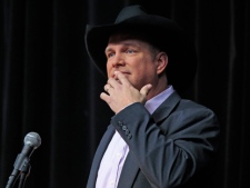 Garth Brooks pauses as he thanks the crowd during an announcement Tuesday, March 6, 2012, that he will be inducted into the Country Music Hall of Fame in Nashville, Tenn. (AP Photo/Mark Humphrey)