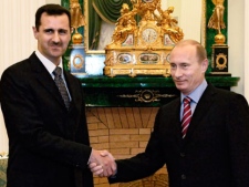 In this Tuesday, Dec. 19, 2006 file photo Vladimir Putin, right, and his Syrian counterpart Bashar Assad smile as they shake hands in Moscow's Kremlin. (AP photo/RIA Novosti, Mikhail Klimentyev, Presidential Press service, file)