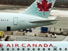 An Air Canada aircraft is unloaded at the Halifax Stanfield International Airport in Enfield, N.S., on Wednesday, March 7, 2012. (THE CANADIAN PRESS/Andrew Vaughan)