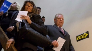 Toronto Mayoral Candidate Doug Ford arrives with wife Karla (centre left) and daughter Krista to cast his ballot in advance voting for the Toronto Municipal Election at an Etobicoke polling station on Wednesday October 15, 2014. Toronto voters pick a new mayor on Oct. 27. THE CANADIAN PRESS/Chris Young