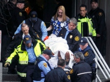 Paramedics and police carry a victim after a shooting at the Western Psychiatric Institute and Clinic in Pittsburgh on Thursday, March 8, 2012. Two people, including the gunman, were killed and seven others were wounded. (AP Photo/Pittsburgh Tribune-Review, Justin Merriman)