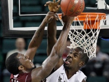 St. Bonaventure's Andrew Nicholson, right, of Canada, goes up to block a shot by Massachusetts' Sean Carter during the second half of an NCAA college basketball game in the semifinals of the Atlantic 10 tournament in Atlantic City, N.J., Saturday, March 10, 2012. St. Bonaventure won 84-80. (AP Photo/Mel Evans) 