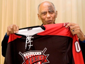 Order of Canada recipient Herb Carnegie, who was a star player with the Quebec Aces through the 1940s, unveils the jersey for the newly proposed NHL expansion team the Toronto Legacy, during a news conference in Toronto on Friday, June 5, 2009. THE CANADIAN PRESS/Darren Calabrese