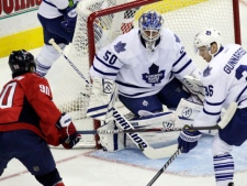 Toronto Maple Leafs goalie Jonas Gustavsson blocks a shot off from Washington Capitals centre Marcus Johansson as Maple Leafs defenceman Carl Gunnarsson defends during an NHL game Sunday, March 11, 2012, in Washington. (AP Photo/Carolyn Kaster)