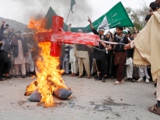 Afghans burn an effigy depicting U.S. President Barack Obama during a protest in Jalalabad, Afghanistan, Tuesday, March 13, 2012, following the killing of civilians in Panjwai, Kandahar by a U.S. soldier. (AP Photo/Rahmat Gul)