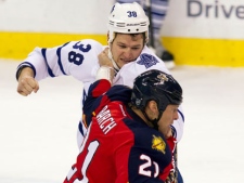 Toronto Maple Leafs' Jay Rosehill (38) and Florida Panthers' Krystofer Barch (21) exchange punches during the first period of an NHL hockey game in Sunrise, Fla., on Tuesday, March 13, 2012. (AP Photo/J Pat Carter)