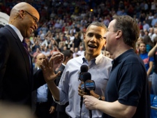 President Barack Obama, center, and Britain's Prime Minister David Cameron are interviewed by CBS Sports' Clark Kellogg, left, during half time of the Mississippi Valley State versus Western Kentucky in a first round NCAA tournament basketball game, Tuesday, March 13, 2012, at University of Dayton Arena, in Dayton, Ohio. (AP Photo/Carolyn Kaster)