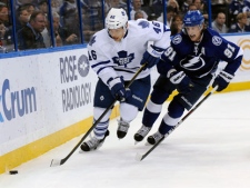 Toronto Maple Leafs right wing Joey Crabb, left, controls the puck against Tampa Bay Lightning center Steven Stamkos during the first period of an NHL hockey game on Thursday, March 15, 2012, in Tampa, Fla. (AP Photo/Brian Blanco)