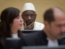 Congolese warlord Thomas Lubanga, center, awaits his verdict in the courtroom of the International Criminal Court (ICC) in The Hague, Netherlands, Wednesday, March 14, 2012. (AP Photo/Evert-Jan Daniels, Pool)