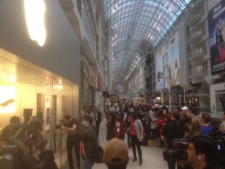 People wait in line outside the Apple Store in Toronto's Eaton Centre before the new iPad officially went on sale Friday, March 16, 2012. (CP24/Cam Woolley)