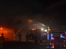 Firefighters battle a blaze at an office building in Oakville on Monday, March 19, 2012. (CP24/Andrew Collins)