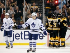 Toronto Maple Leafs right wing Joey Crabb skates back to the bench as the Boston Bruins celebrate one of their four goals during the first period of an NHL hockey game in Boston on Monday, March 19, 2012. (AP Photo/Winslow Townson)