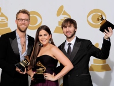 From left, Charles Kelley, Hillary Scott and Dave Haywood, of musical group Lady Antebellum, pose backstage with the awards for best country album for "Own the Night" at the 54th annual Grammy Awards on Sunday, Feb. 12, 2012 in Los Angeles. (AP Photo/Mark J. Terrill)
