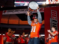 B.C. Lions wide receiver Geroy Simon hoists the Grey Cup at an event for fans to celebrate the team's Grey Cup victory in Vancouver, B.C., on Wednesday November 30, 2011. The B.C. Lions defeated the Winnipeg Blue Bombers to win the CFL's 99th Grey Cup game on Sunday. THE CANADIAN PRESS/Darryl Dyck