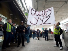Air Canada ground workers hold a wildcat strike at Toronto's Pearson International Airport on Friday, March 23, 2012. (THE CANADIAN PRESS/Aaron Vincent Elkaim)