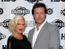 In this July 7, 2011 file photo, actress Tori Spelling, left, and actor Dean McDermott arrive at the premiere of the feature film "Gun Hill Road" in Los Angeles. Spelling announced on her Website that she and husband Dean were expecting their fourth child. (AP Photo/Dan Steinberg)