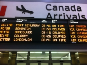 An arrivals board shows delayed flights at Pearson International Airport's Terminal 1 early Friday, March 23, 2012, after Air Canada baggage handlers began staging a wildcat strike at the airport. (CP24/Tom Stefanac)