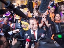 NDP leadership candidate Brian Topp, centre, speaks to the media after the third ballot results during the NDP leadership convention in Toronto on Saturday, March 24, 2012. THE CANADIAN PRESS/Pawel Dwulit