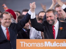 New NDP Leader Thomas Mulcair, right, reacts with Brian Topp, left, on stage during the NDP leadership convention in Toronto on Saturday, March 24, 2012. THE CANADIAN PRESS/Frank Gunn