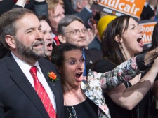 NDP leadership candidate Thomas Mulcair, left, and his wife react to the second ballot results during the NDP leadership convention in Toronto on Saturday, March 24, 2012. THE CANADIAN PRESS/Frank Gunn