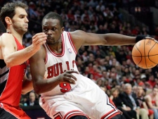 Chicago Bulls forward Luol Deng (9) drives to the basket as Toronto Raptors guard Jose Calderon (8) during the second half of an NBA basketball game in Chicago, Saturday, March 24, 2012. The Bulls won 102-101. (AP Photo/Nam Y. Huh)