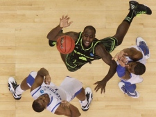 Kentucky's Marquis Teague, right, and Kentucky's Darius Miller work for a rebound with Baylor's Quincy Acy (4) during the second half of an NCAA tournament South Regional finals college basketball game Sunday, March 25, 2012, in Atlanta. (AP Photo/David J. Phillip) 